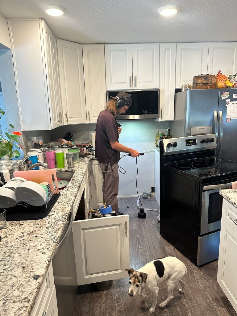 Tyler with I Find Leaks uses advanced machines to locate a leak on a Pinellas County Leak Detection job.