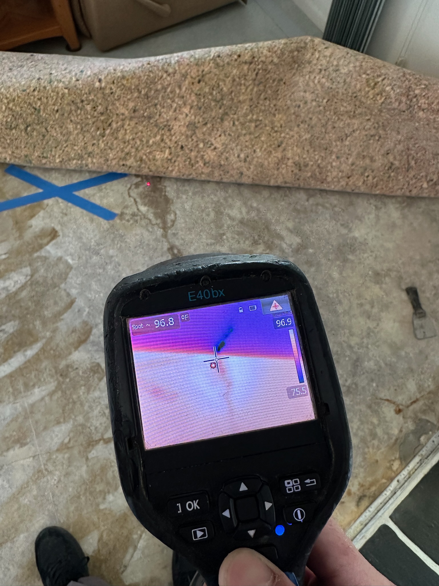 A flir infrared camera looking at a concrete floor where a slab leak is located in Seminole Florida.