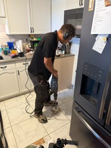 Brock jackhammering a tile floor on a Clearwater slab leak detection job.