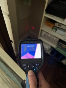 Tyler with I Find Leaks using a Flir Infrared camera to perform an inspection on a Kenneth City water leak job.