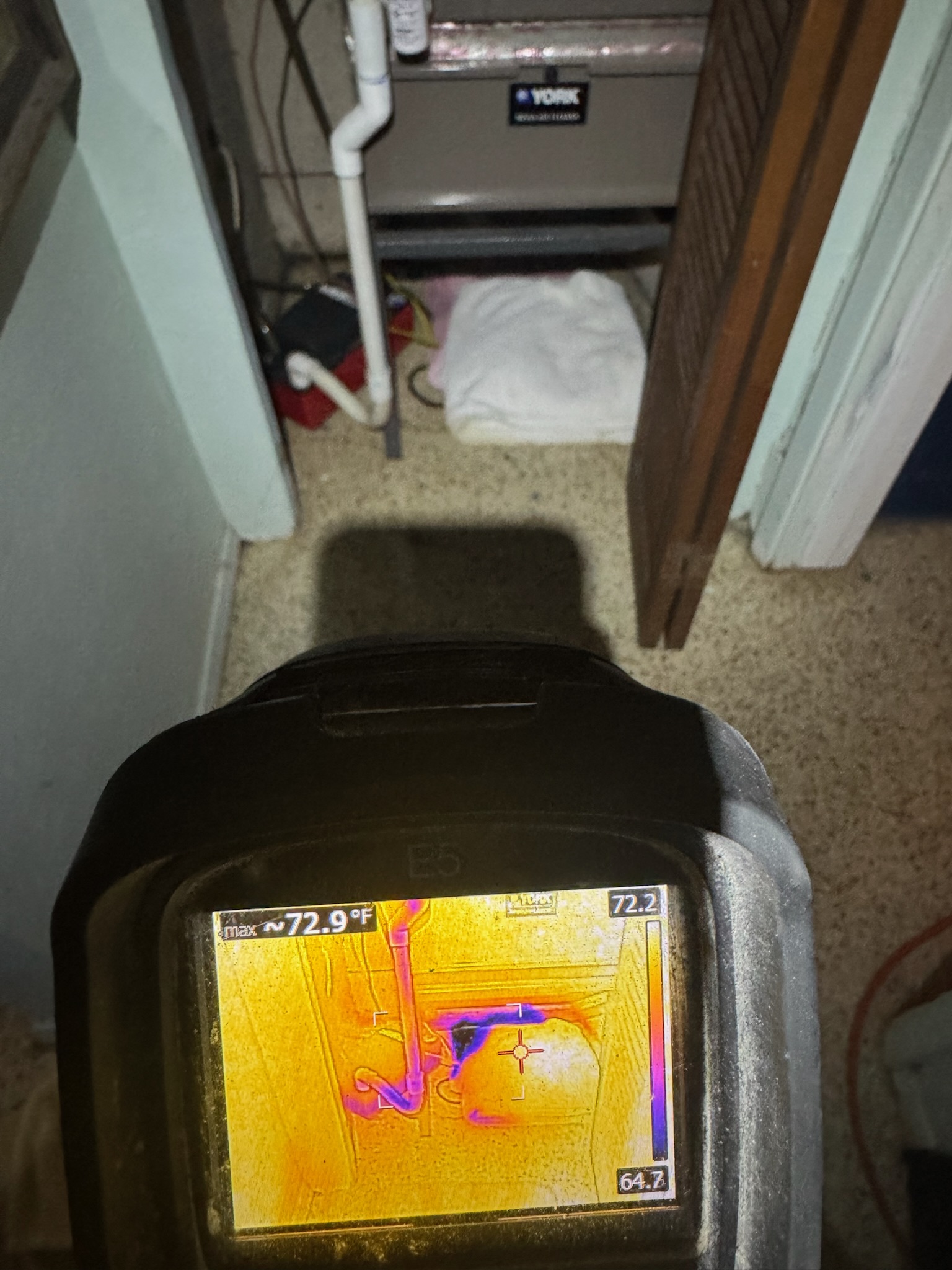 A Flir infrared camera inspecting under an AC handler for a leak in St Petersburg.