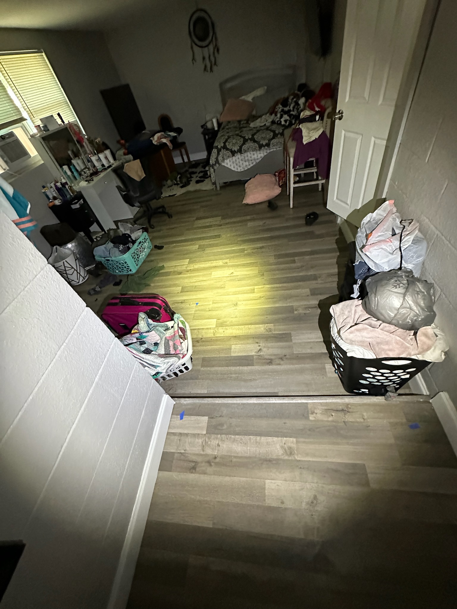 Clearwater bedroom vinyl floor marked with tape due to long-term water intrusion.