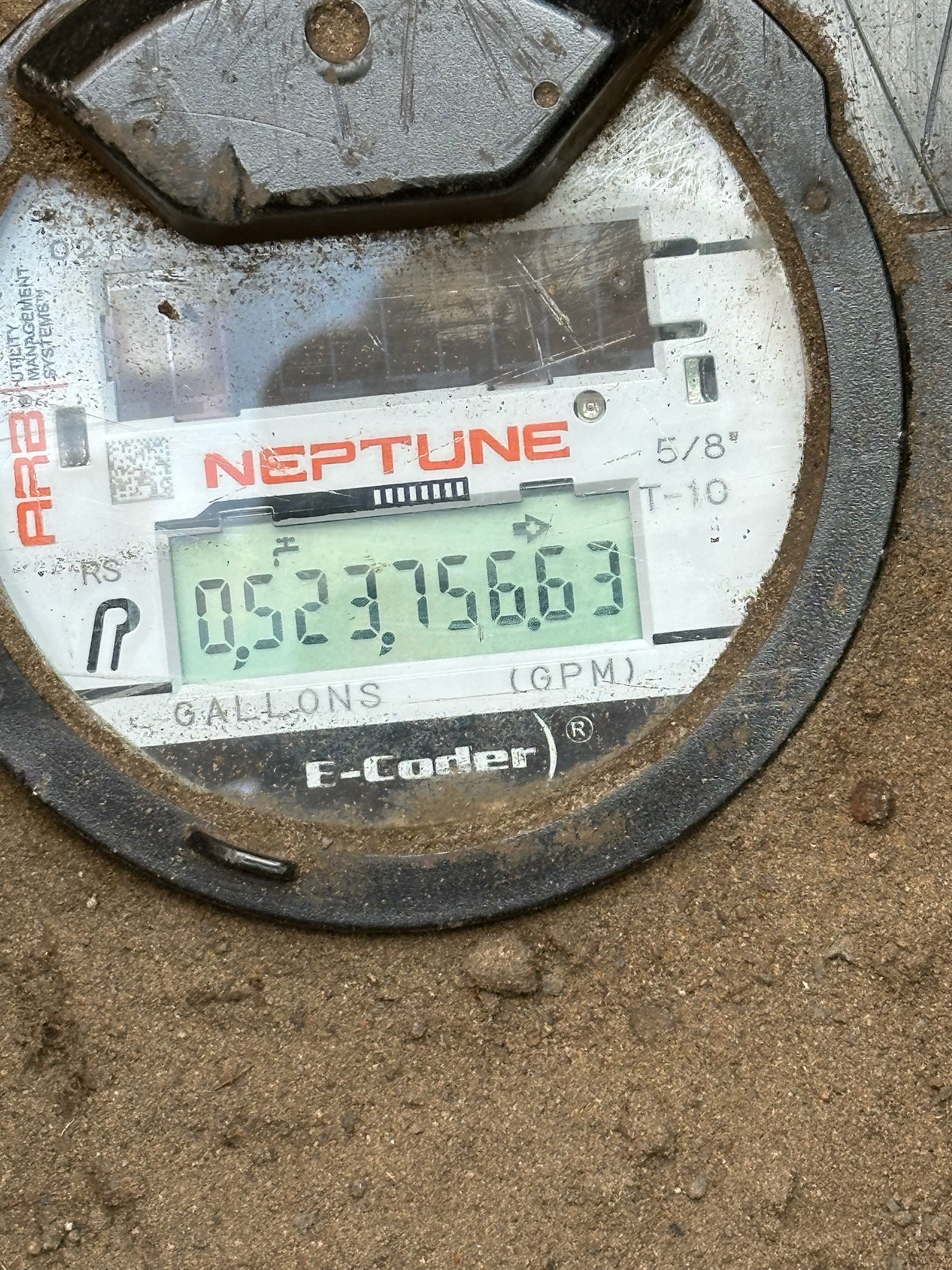 A digital water meter indicating flow with a small arrow that flashes when there is water going through the meter.