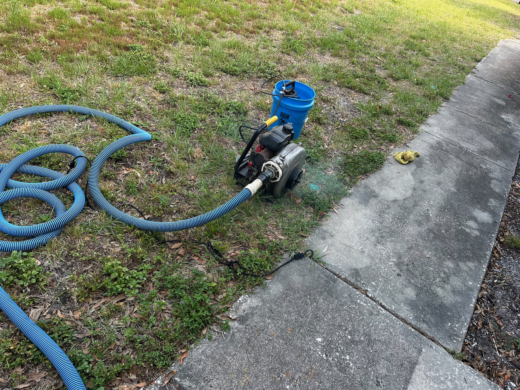 Hurco smoke machine with hose setup on a sidewalk for sewer odor detection in Pinellas County, Florida.