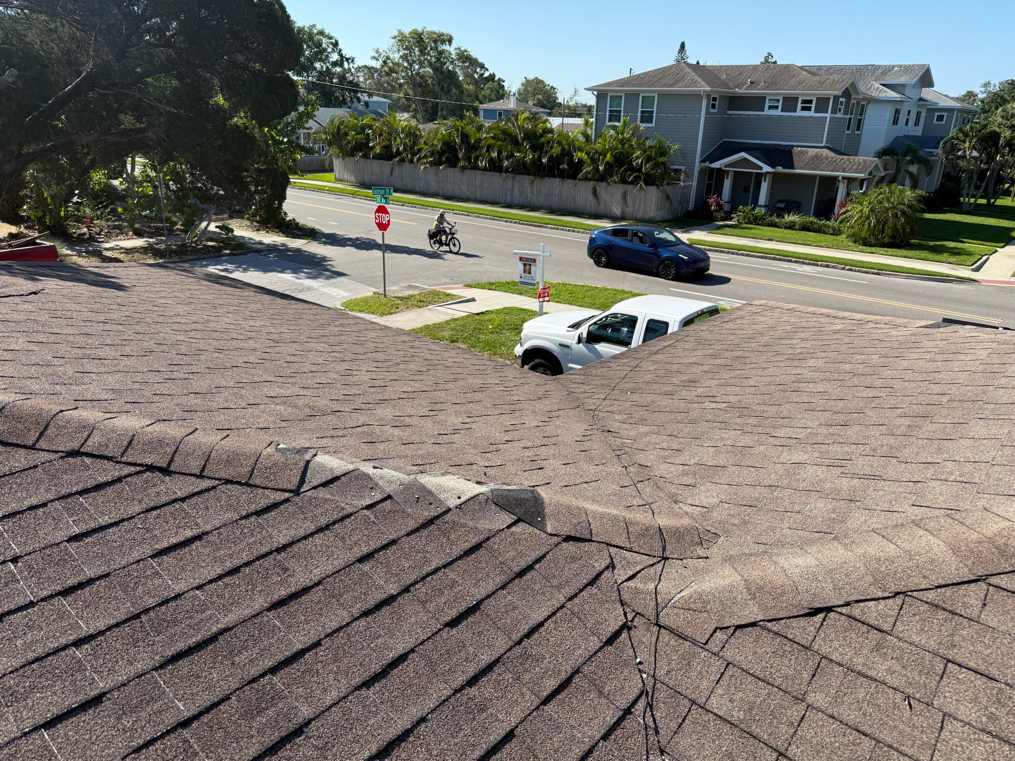 View from roof showing white truck below at Clearwater sewer inspection site