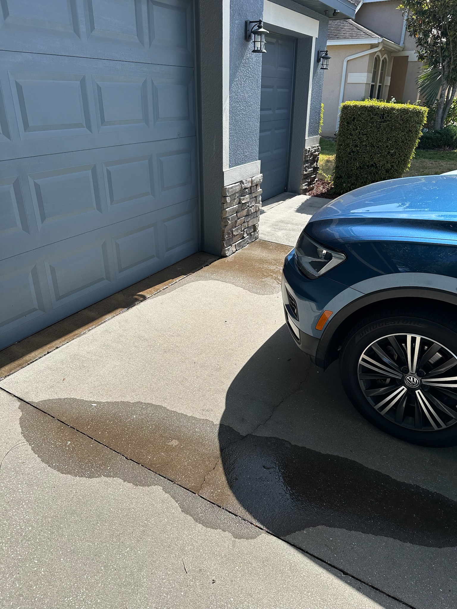 Water leaking near garage door and brick fascia at Tampa home with high water bill