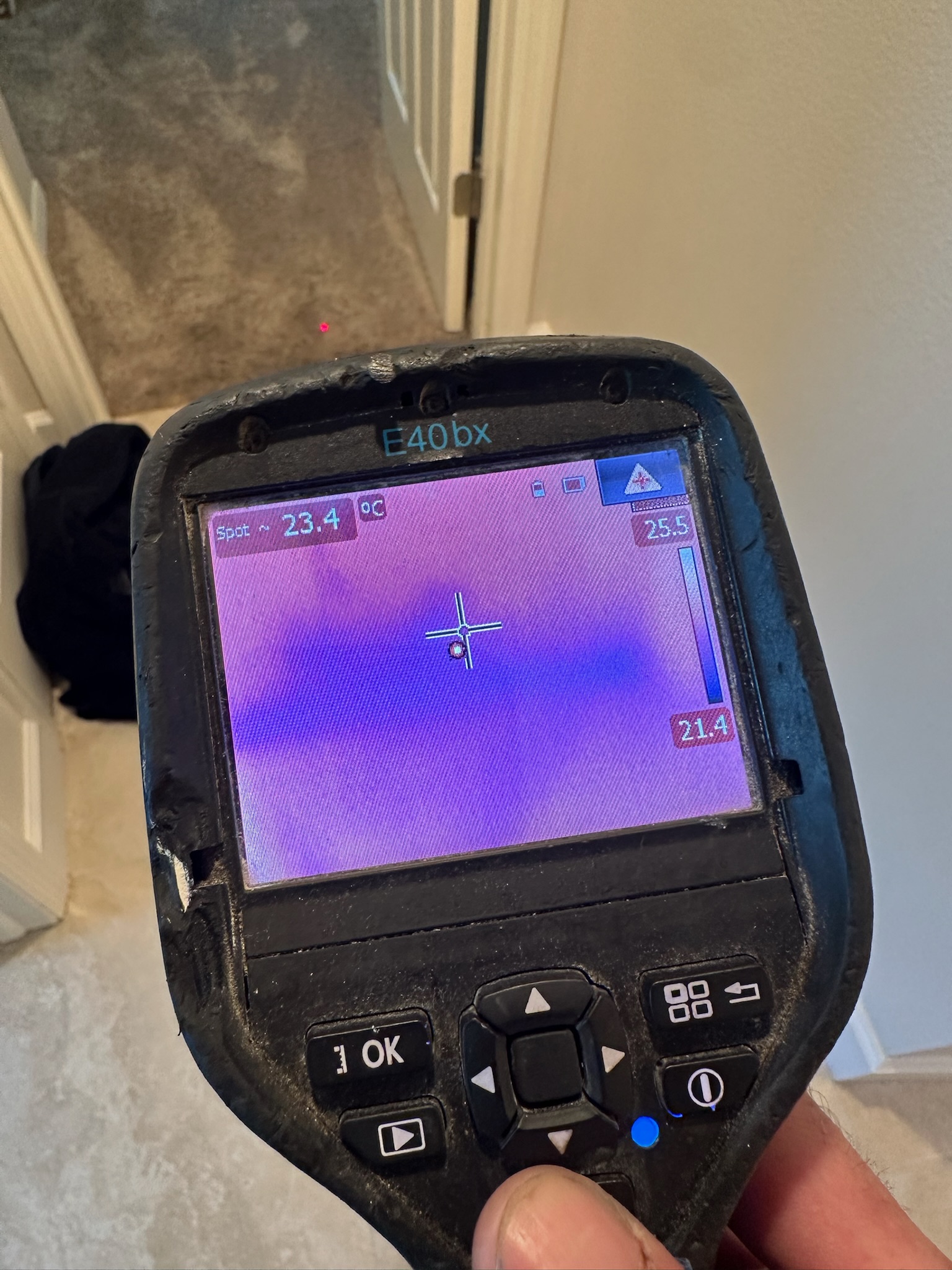 Infrared image showing moisture in carpet near a bedroom entrance, 20 feet from the garage leak source in a Westchase home.