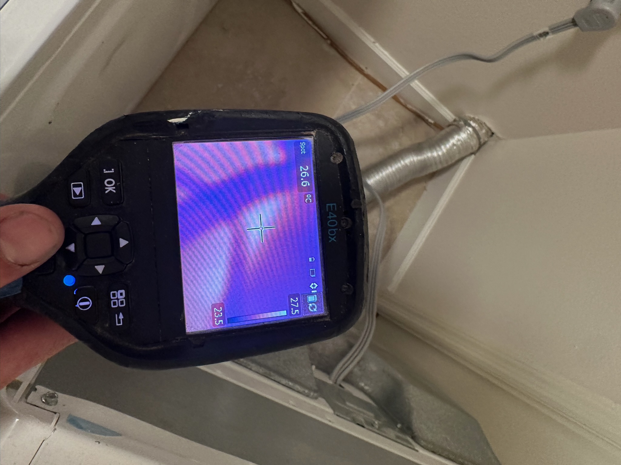 Infrared image showing moisture near the dryer vent behind the laundry area wall in a Westchase home.