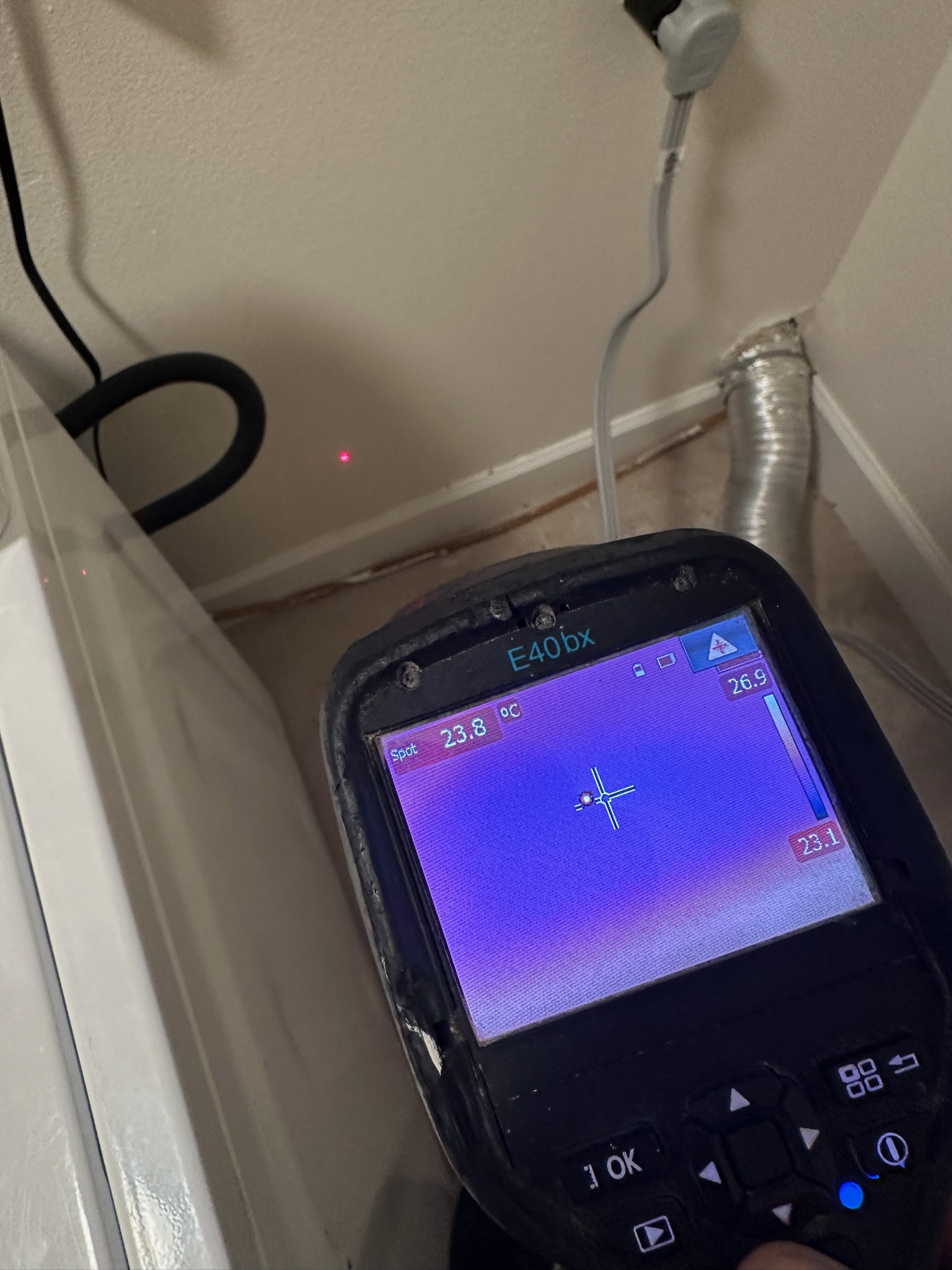 Infrared image showing hidden moisture behind a dryer wall in a Westchase home.