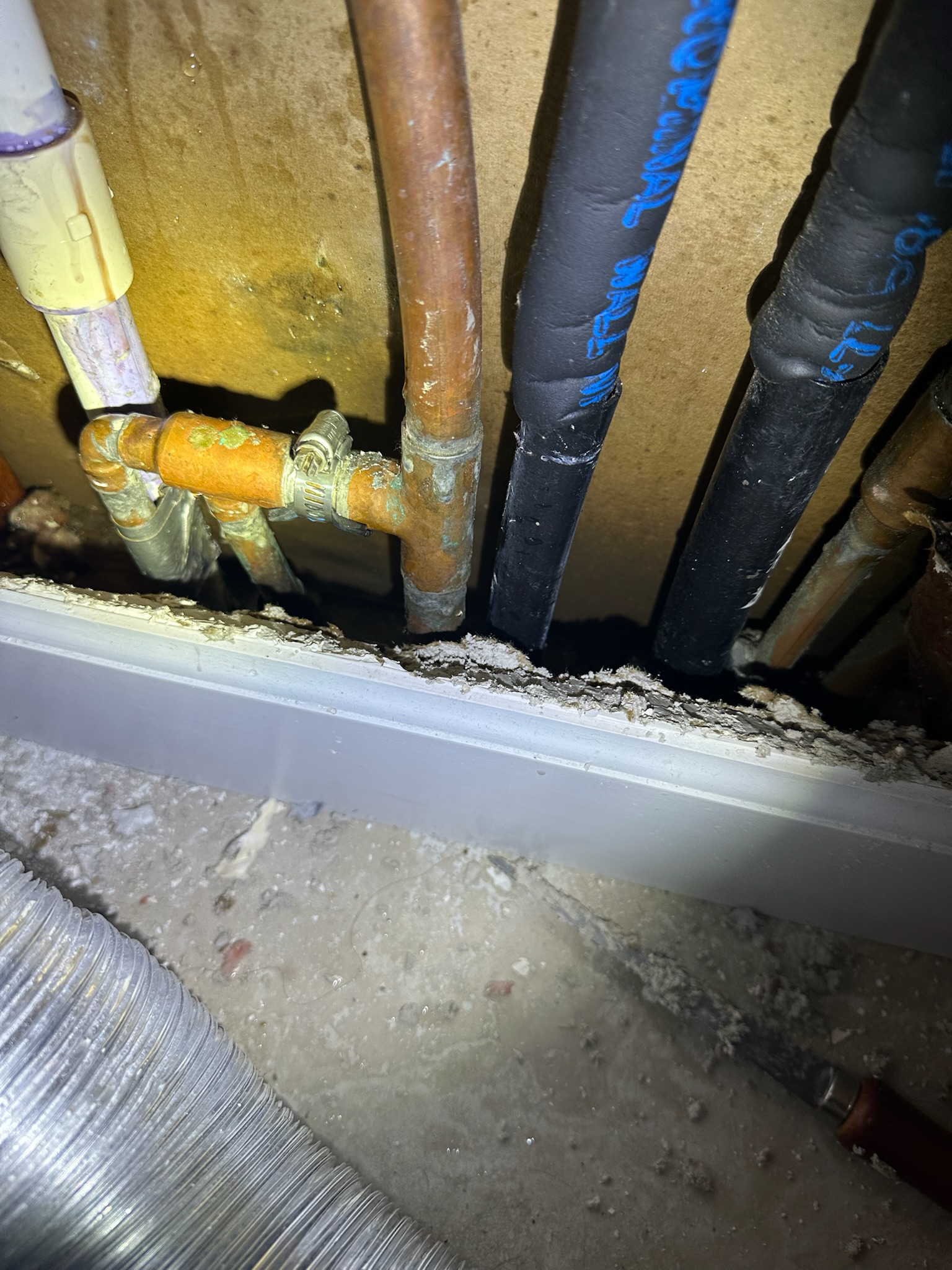 Temporary rubber and hose clamp repair on a copper pipe in a Westchase home to stop an active leak until permanent repair.