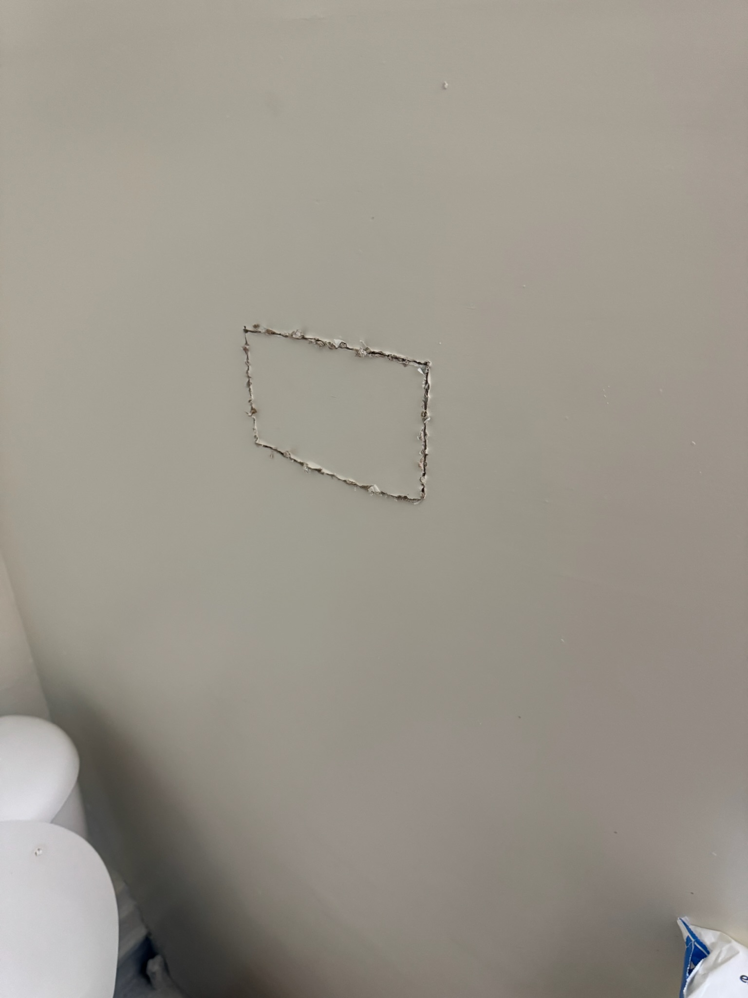 Minimal drywall access to leak Small drywall square cut to access pinpointed leak in St. Petersburg bathroom