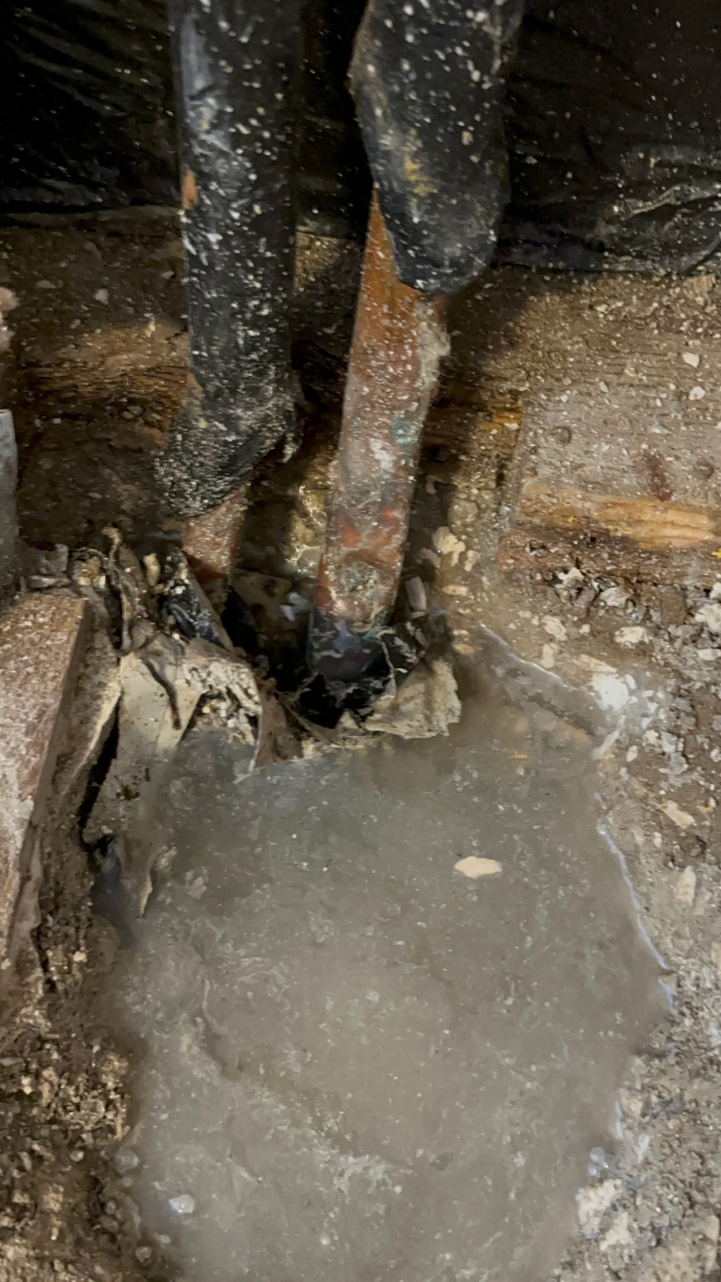 Close-up of active copper pipe water leak inside wall of Northeast St. Petersburg home