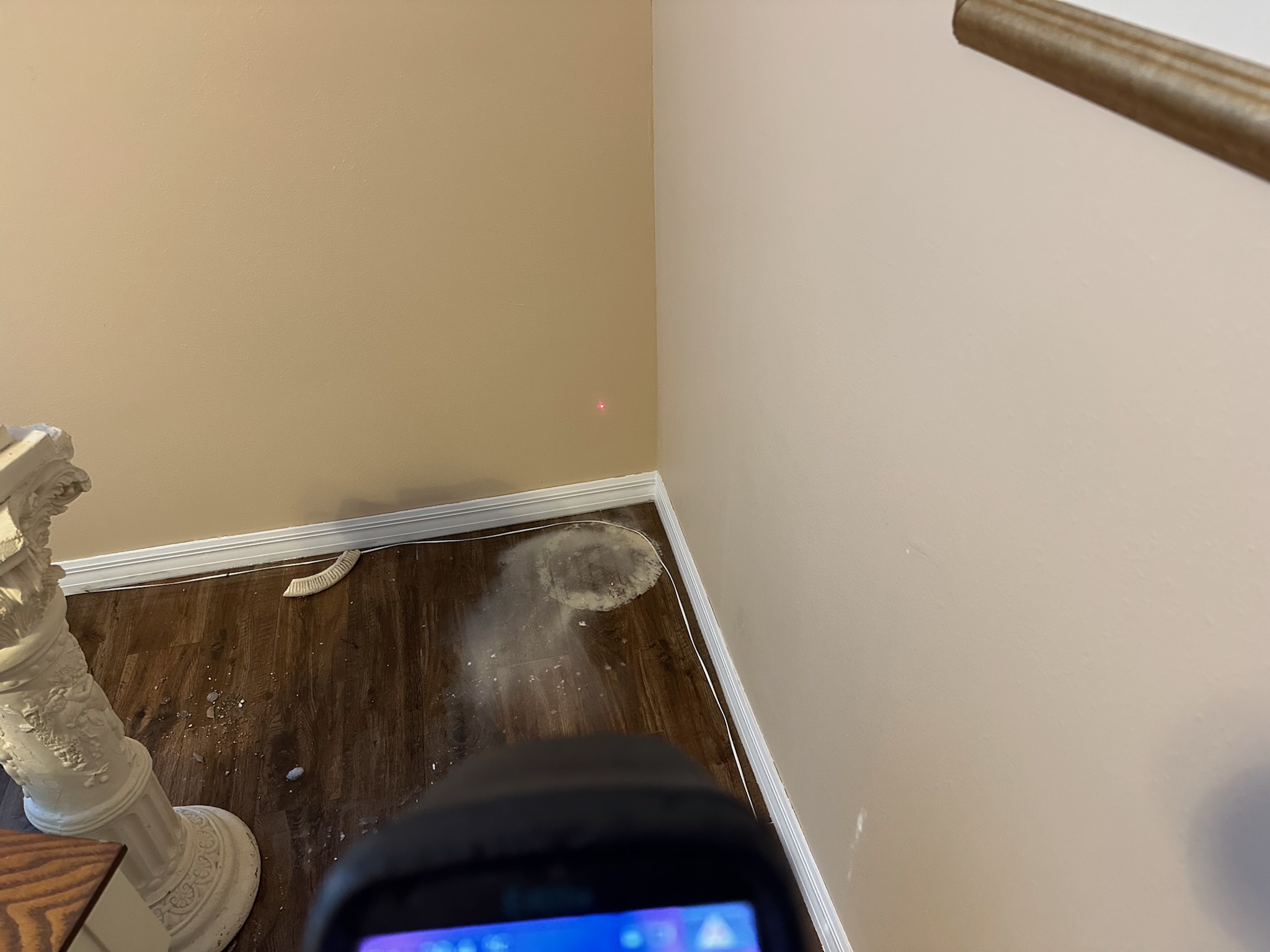 Infrared camera inspection of wood floor corner in Northeast St. Petersburg home checking for hidden water leak near custom baseboards