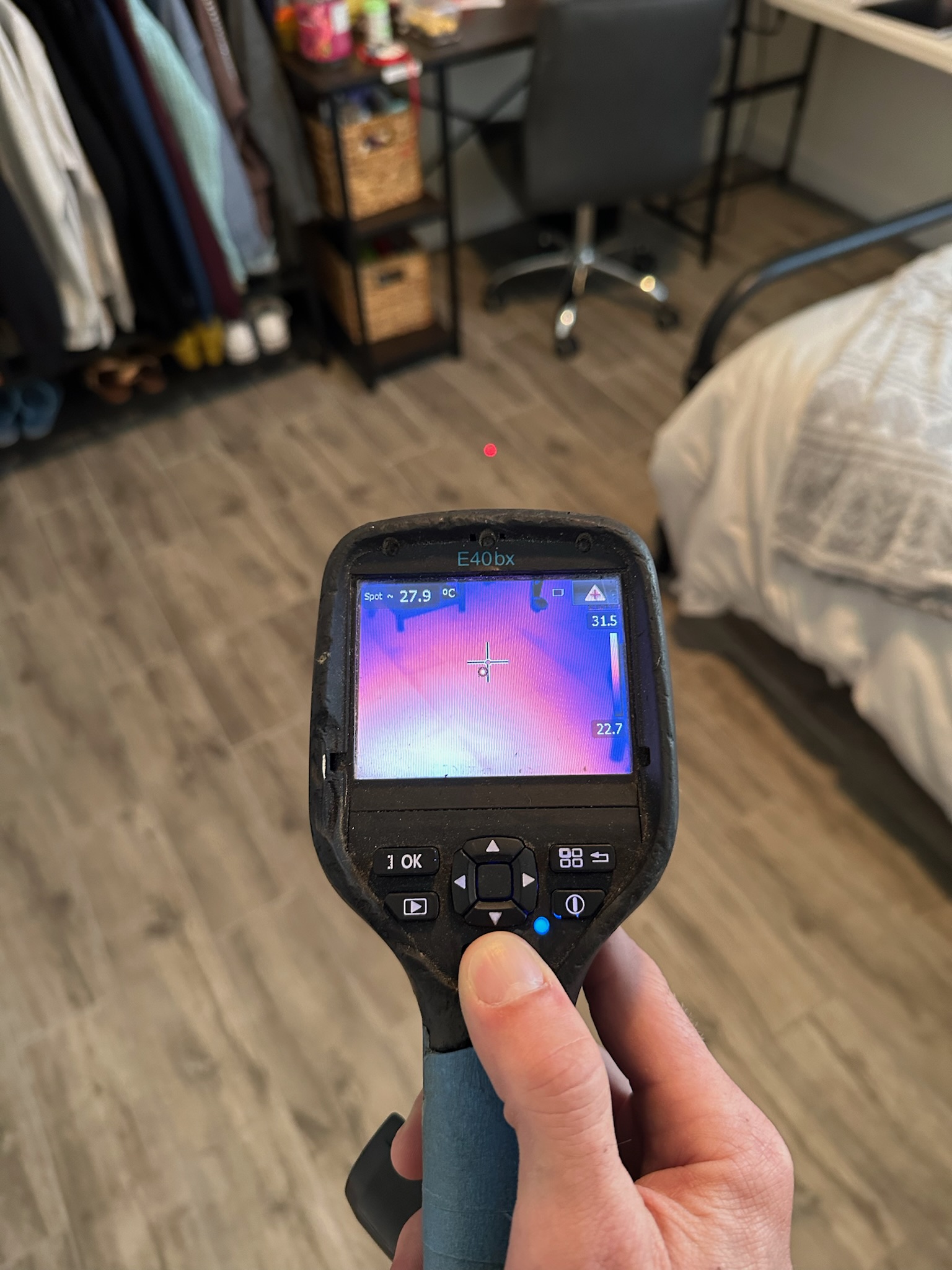 Infrared camera shows hot spot under bedroom floor during high water bill investigation in St. Petersburg home