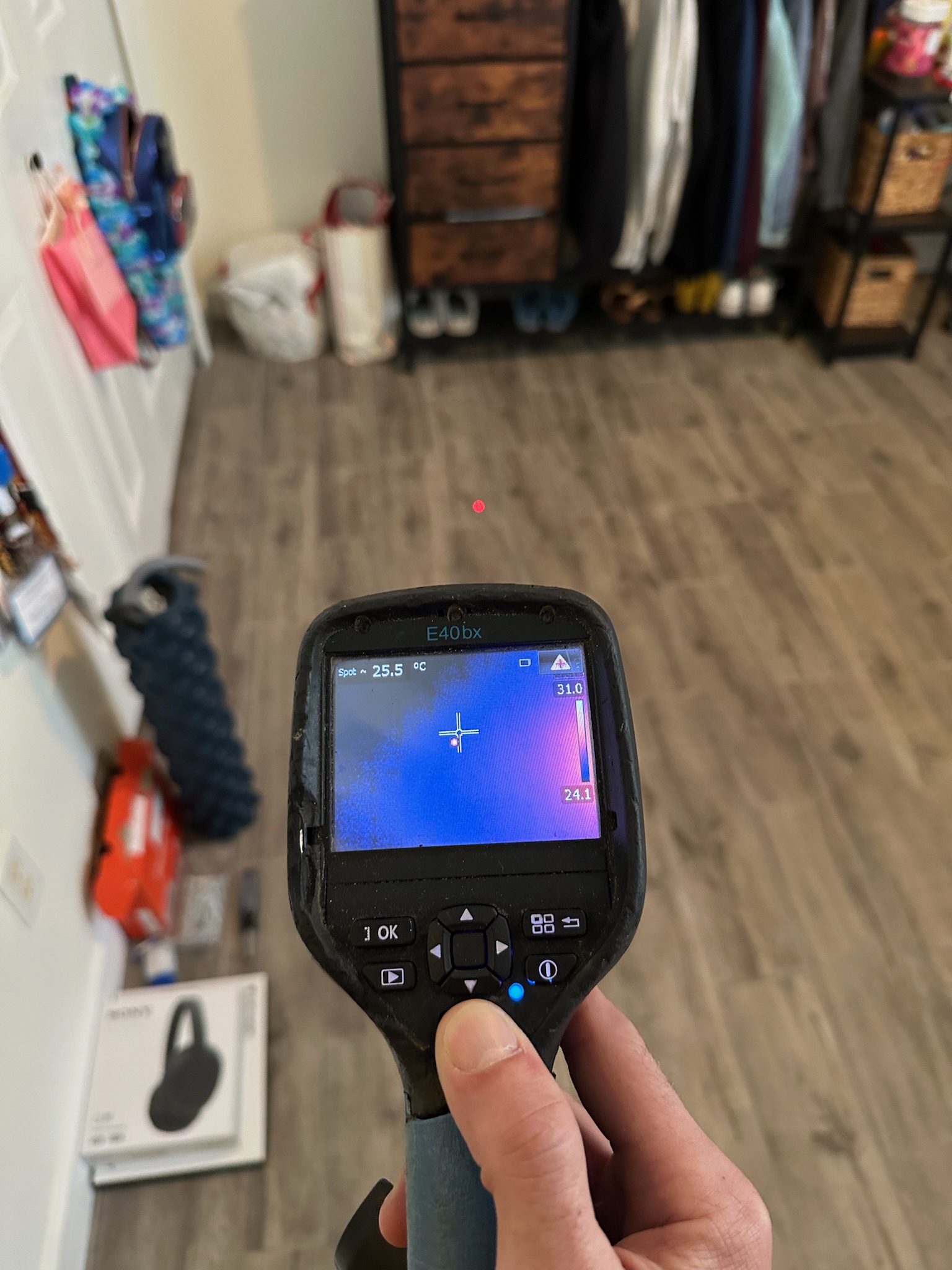 Infrared camera scan of bedroom floor during high water bill investigation in St. Petersburg home