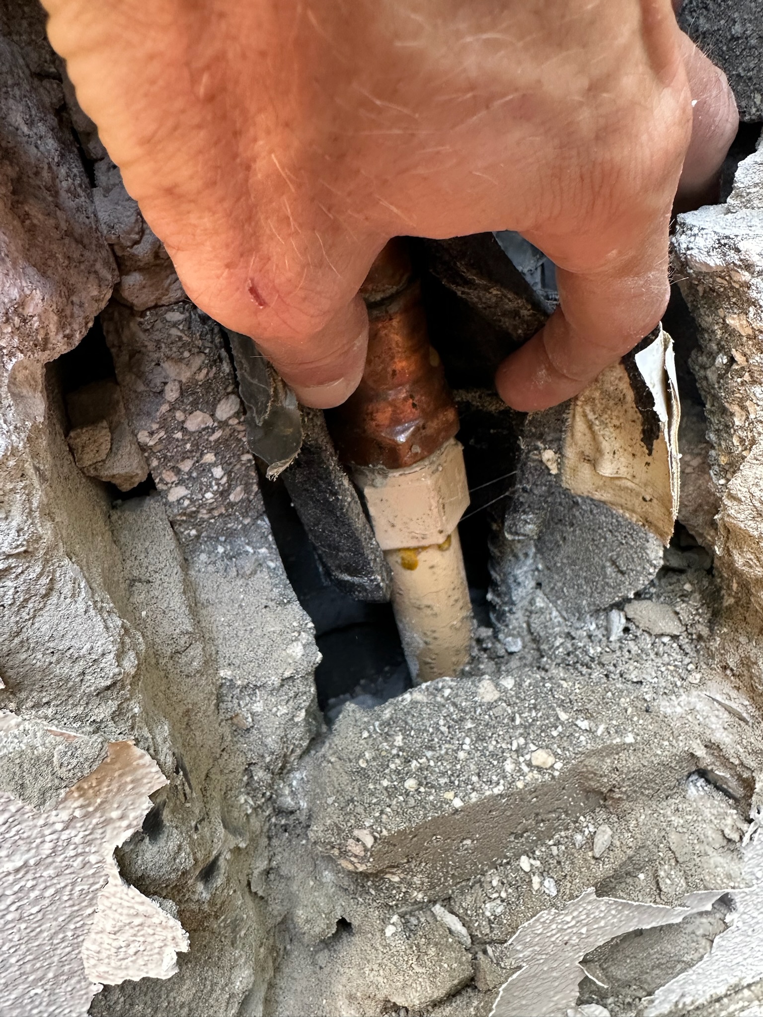 Copper to CPVC pipe leak exposed in block wall in Largo FL