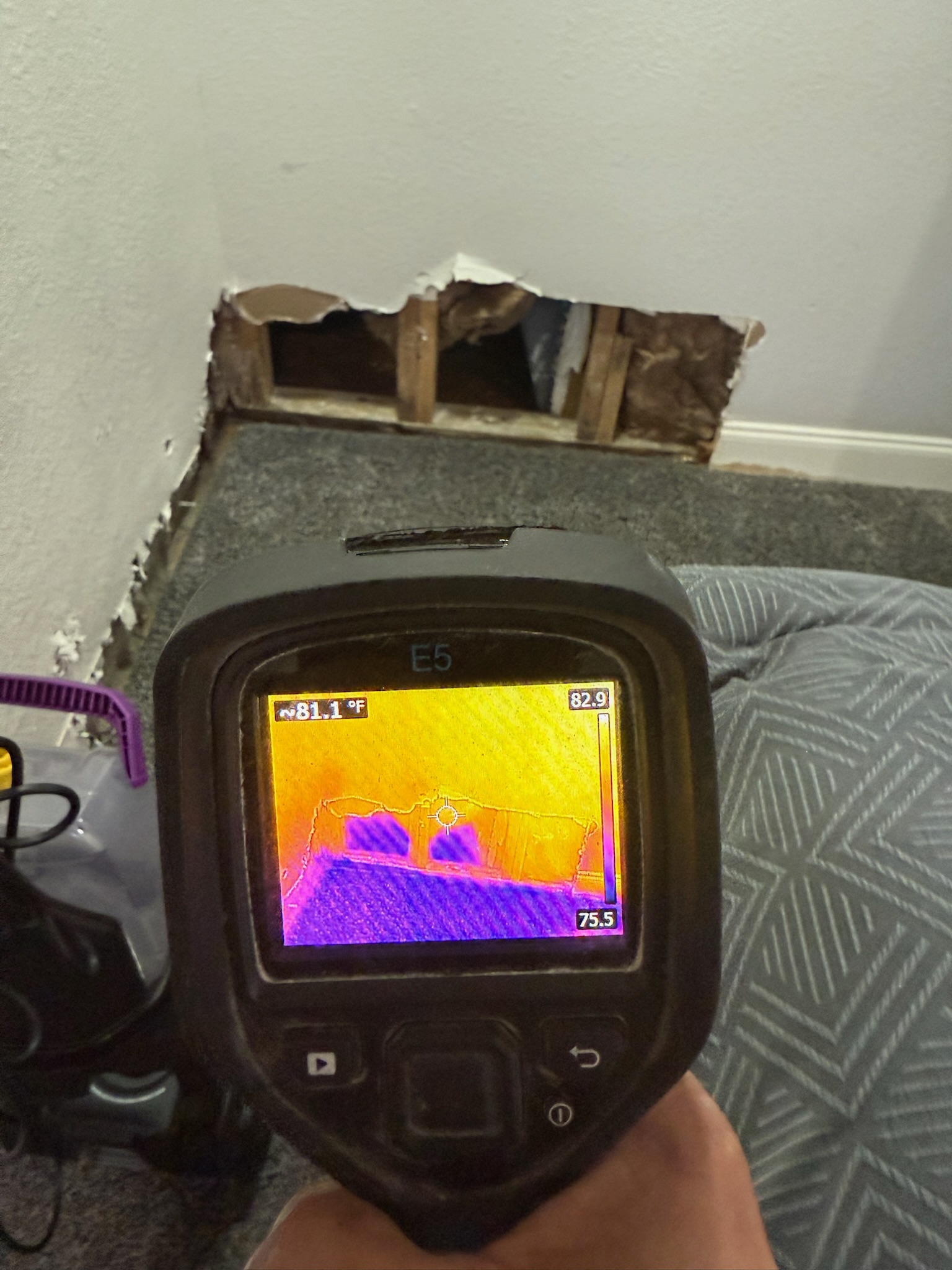 Bedroom corner in a St. Petersburg home showing prior baseboard and wall openings during a professional water leak detection inspection.
