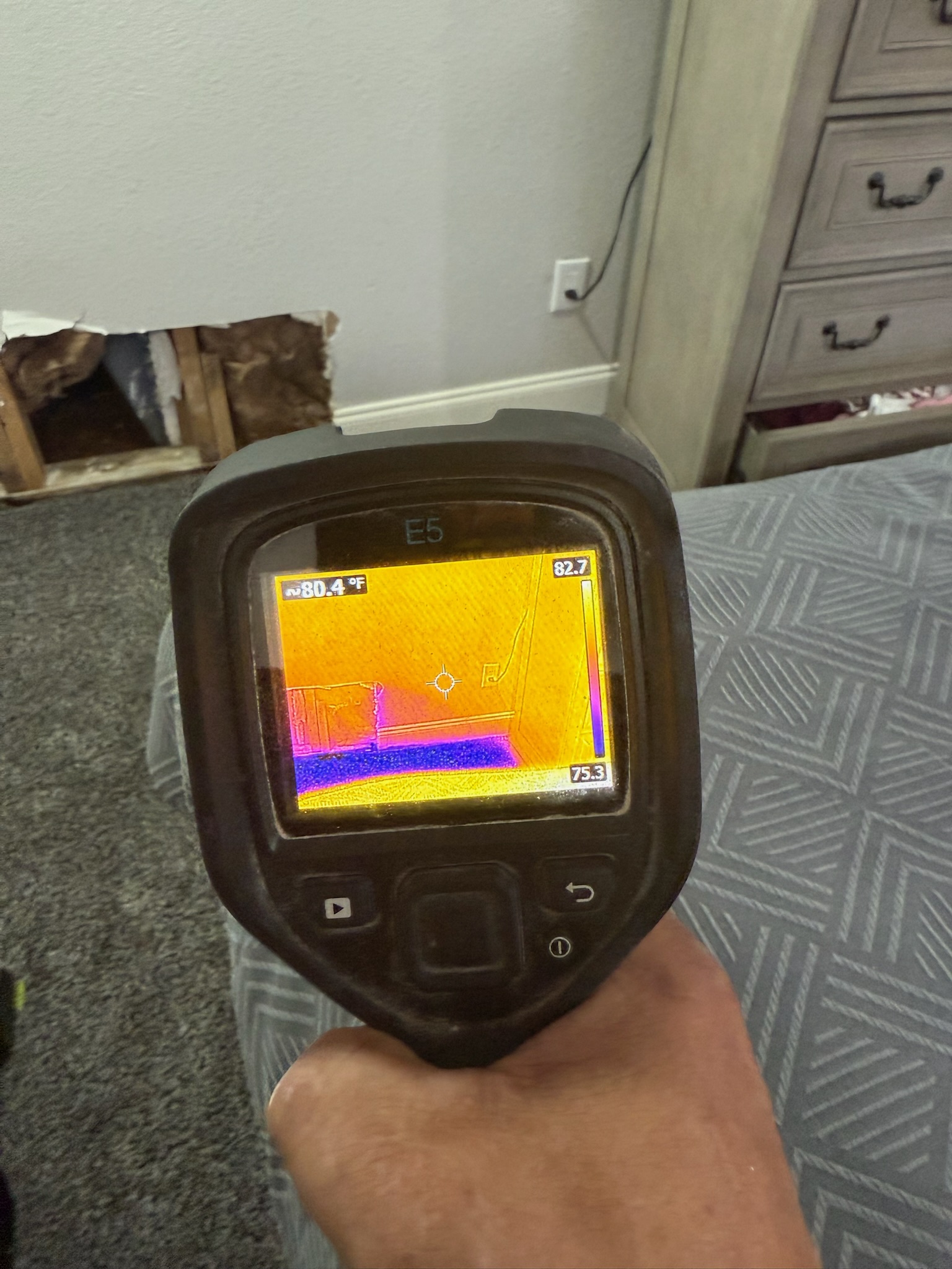I Find Leaks technician using a FLIR infrared camera during a bedroom leak inspection in St. Petersburg, Florida.