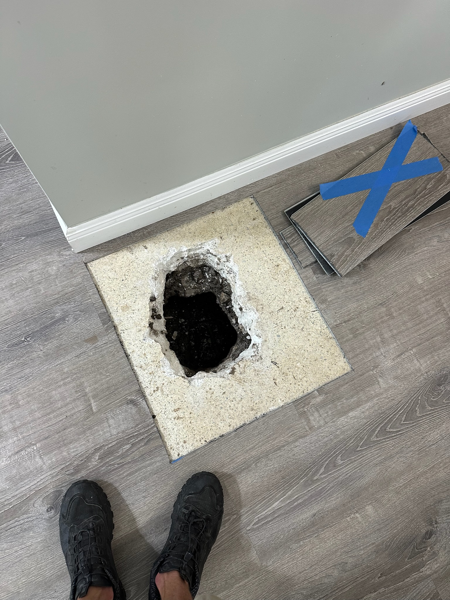 Clean access opening in terrazzo floor after slab leak was located in Clearwater home