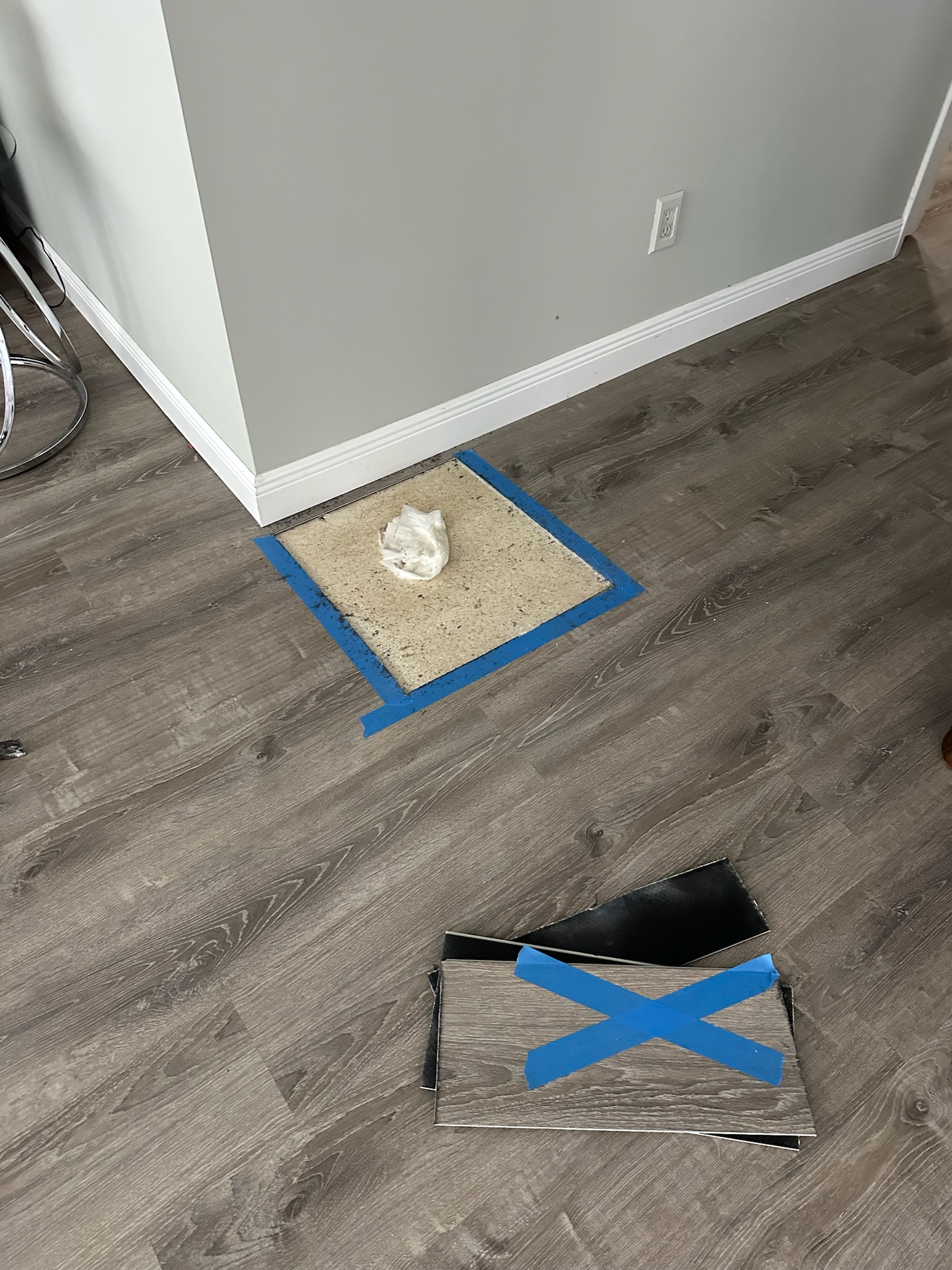 Laminate floor removed to expose terrazzo before slab leak access in Clearwater home