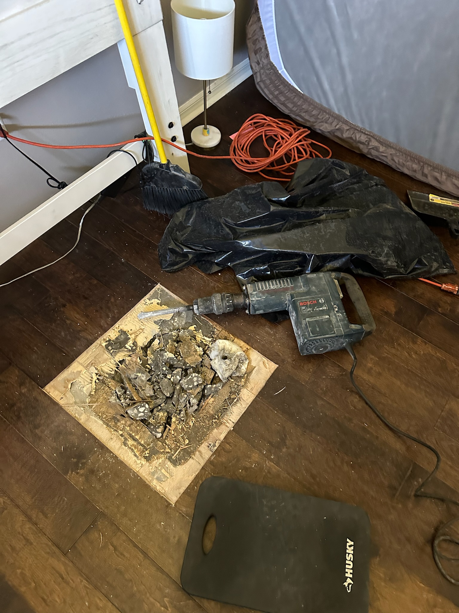 Oldsmar Water Leak Detection - Bedroom Slab Access with Bosch Jackhammer Bosch jackhammer used to open the concrete slab at a verified bedroom leak location during an Oldsmar water leak detection job.