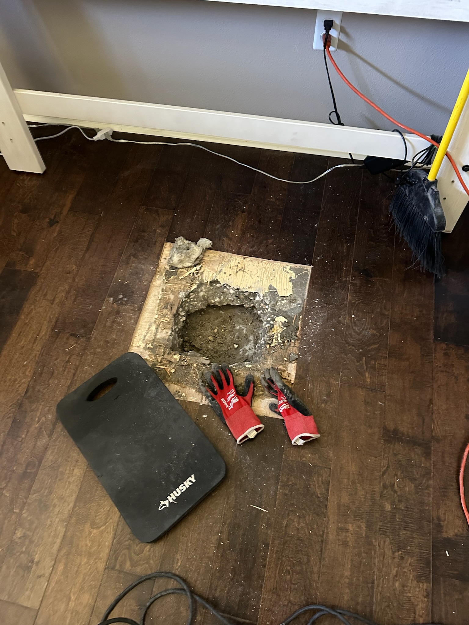 Oldsmar Water Leak Detection - Under Slab Access After Concrete Removal Concrete removed from a bedroom slab in Oldsmar with dirt exposed below during a targeted water leak detection inspection.