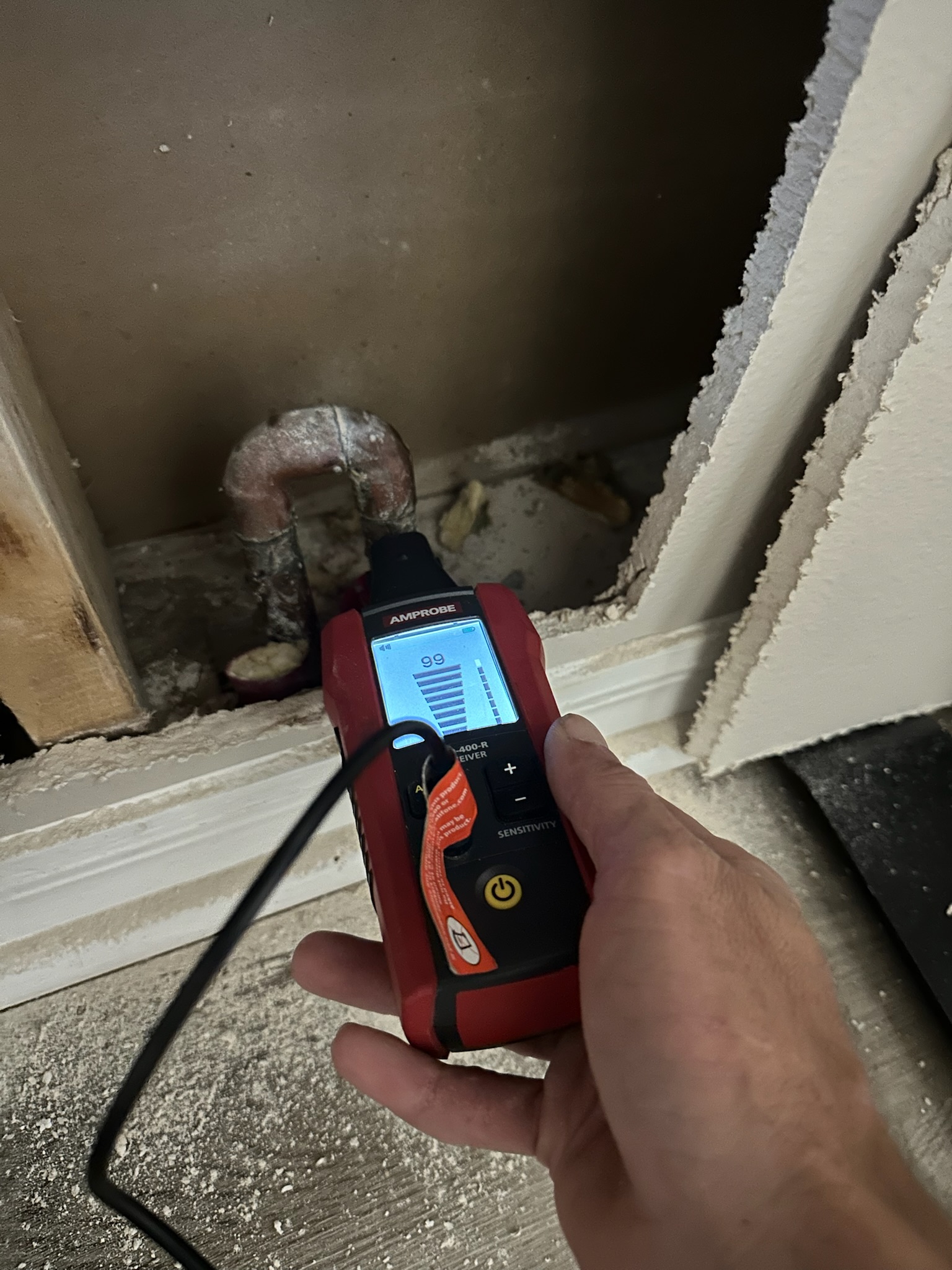 Tyler uses ultrasonic leak detection device on copper pipe manifold during St. Petersburg leak detection job