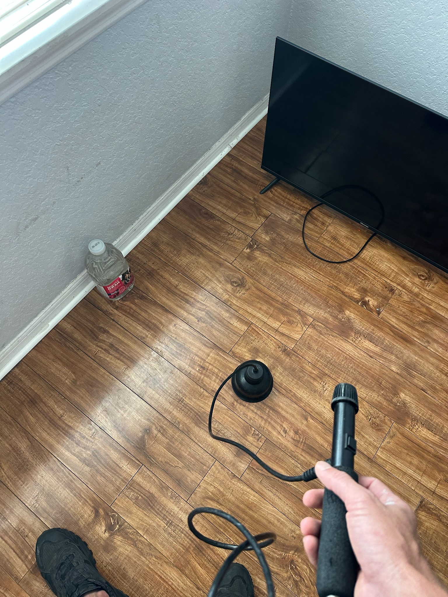 Pinellas County high water bill acoustic slab leak detection through wood floor Tyler uses acoustic leak detection equipment on wood floor during Pinellas County high water bill investigation