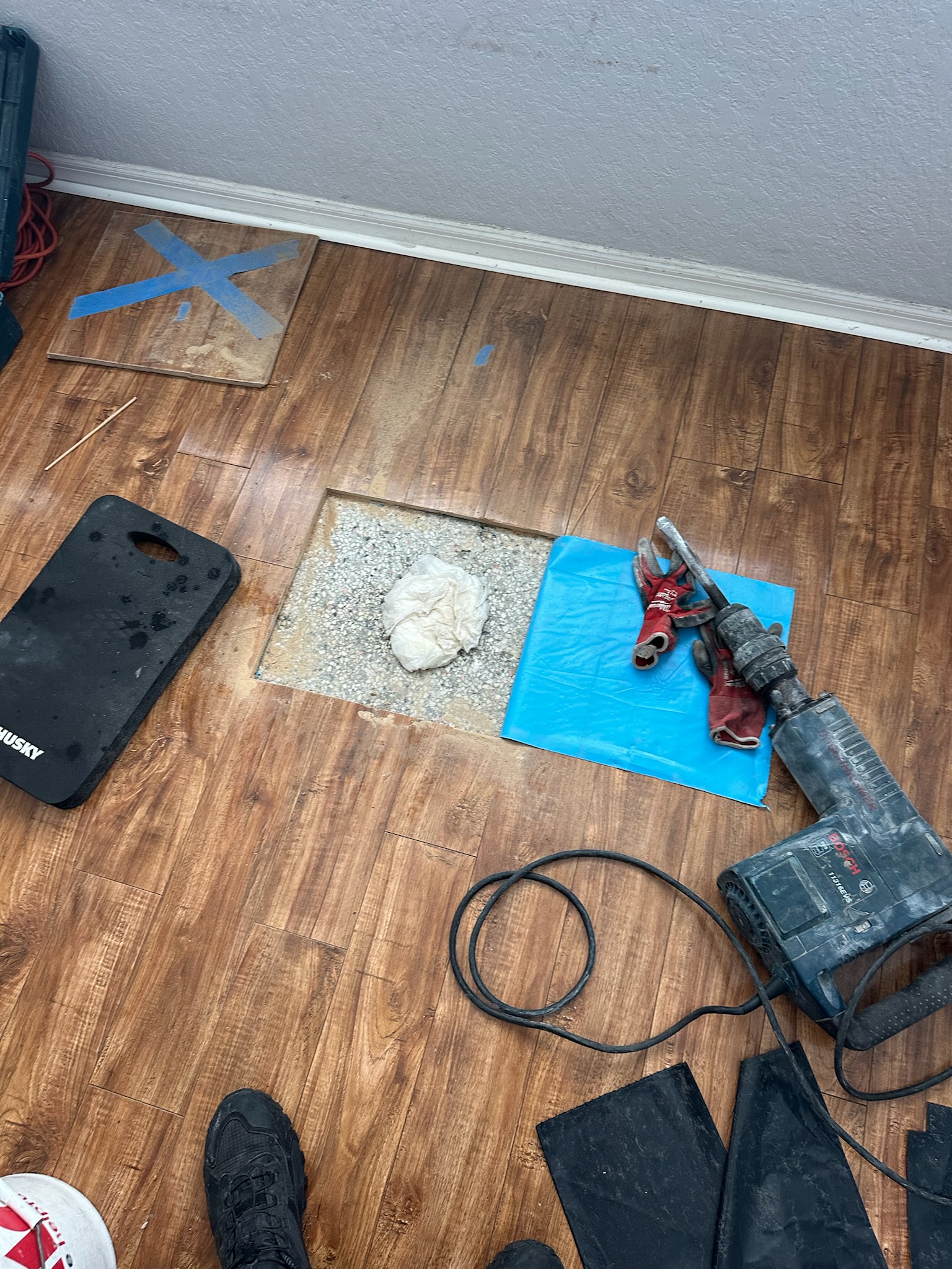 Pinellas County high water bill slab leak wood floor access preparation Square cut in wood floor exposes terrazzo before slab leak access during Pinellas County high water bill investigation