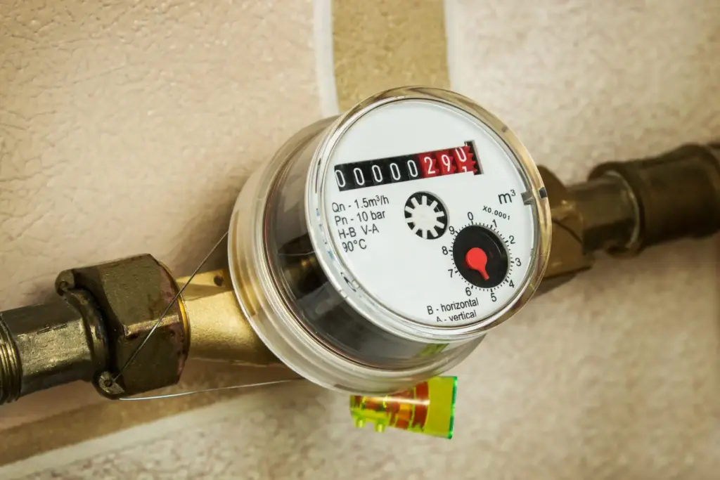Water meter with its red leak indicator dial