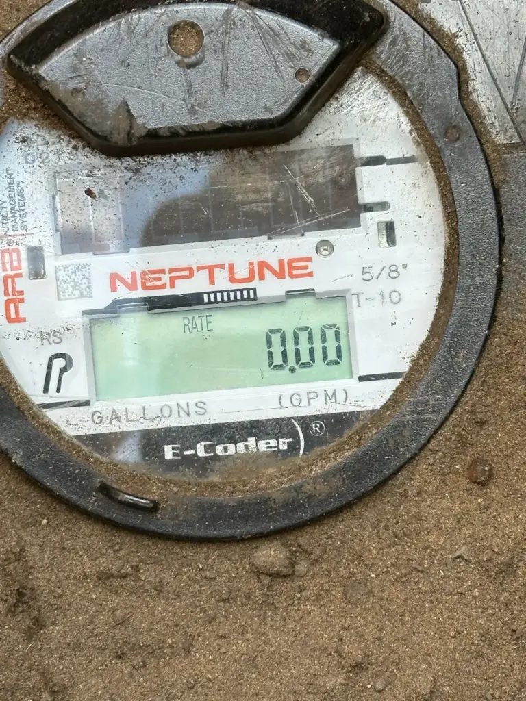 Digital water meter display reading 0.00 gallons per minute.